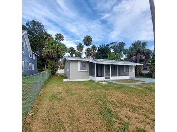 Newly painted house with a screened porch and large yard at 325 Garden St, Daytona Beach, FL 32114