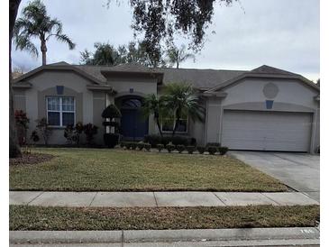 Single-story house with a two-car garage and well-maintained lawn at 766 Bryson Loop, Lakeland, FL 33809