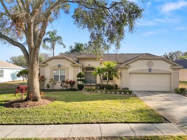 Charming single-story home featuring lush landscaping and a well-manicured lawn at 766 Bryson Loop, Lakeland, FL 33809