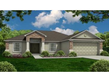Charming one-story home featuring stone accents, a well-manicured lawn, and an attached two-car garage at 3325 Berkley Dr, Bartow, FL 33830