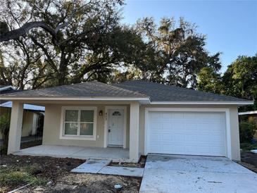 Charming single-story home with a well-maintained front yard and attached garage at 412 Avenue M Ne, Winter Haven, FL 33881