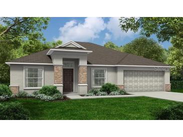 Charming single-story home with stone accents, well-manicured lawn, and an attached two-car garage at 121 W 6Th St, Frostproof, FL 33843