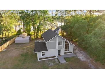 Stunning home exterior featuring a new roof and lush green surroundings at 2449 E Lake Dr, Deland, FL 32724