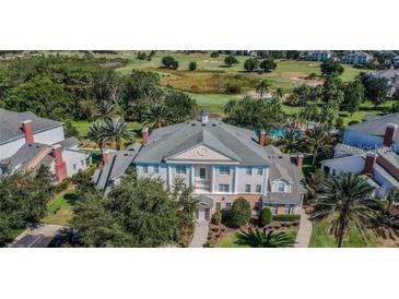 A lovely multi-story condo with well maintained landscaping and a view of the lush golf course at 7697 Heritage Crossing Way # 302, Reunion, FL 34747