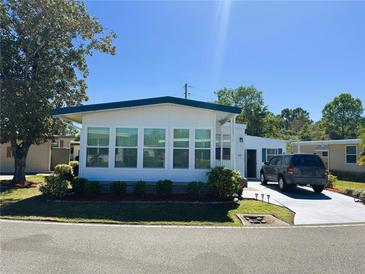 Charming single-story home with well-manicured lawn and ample parking space at 123 Pyracantha Ln, Leesburg, FL 34748