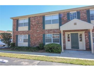 Charming two-story condo with brick facade, inviting entrance, and well-maintained landscaping at 1920 E Edgewood Dr # D1, Lakeland, FL 33803