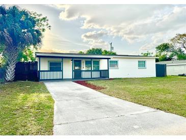 Charming single-story home with a well-maintained lawn and long driveway at 2336 Nansen Ave, Orlando, FL 32817