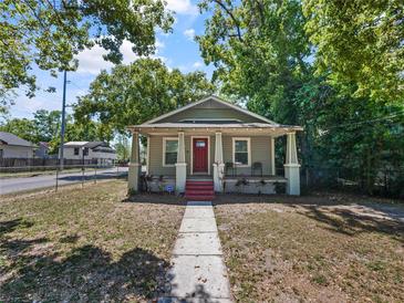Charming single-story home with a welcoming front porch and red front door at 302 W Park St, Lakeland, FL 33803