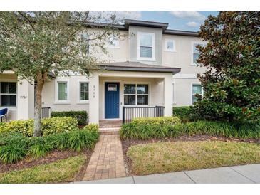 Charming townhome featuring a well-maintained front yard and covered entry at 9790 Amber Chestnut Way, Winter Garden, FL 34787