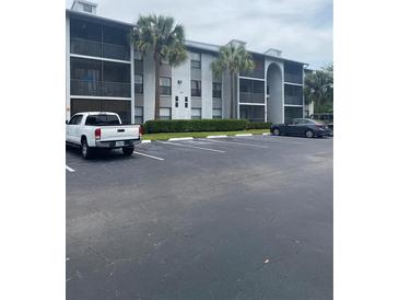 Condo exterior featuring well-maintained landscaping and ample parking at 1134 S Pine Ridge Cir # 34, Sanford, FL 32773