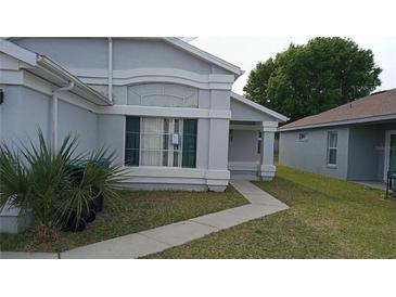 Charming single-story home featuring well-maintained landscaping and a welcoming entrance at 1484 Avleigh Se Cir, Orlando, FL 32824
