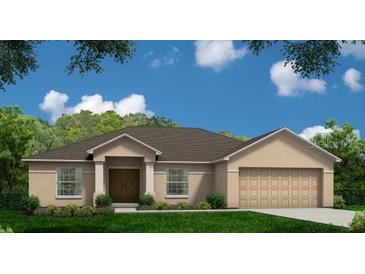 Charming single-story home with a well-maintained lawn and a two-car garage at 150 Minnesota Ave, Babson Park, FL 33827