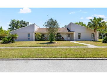 Charming one-story home with well-manicured lawn and mature landscaping at 34 Misty Meadow Ln, Mulberry, FL 33860