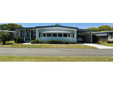 Charming single-story home with a carport and well-maintained landscaping at 511 Hawthorne Blvd, Leesburg, FL 34748