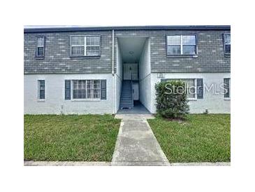 Charming two-story condo with walkway, well-maintained lawn, and neutral color palette at 1000 S Semoran Blvd # 408, Winter Park, FL 32792