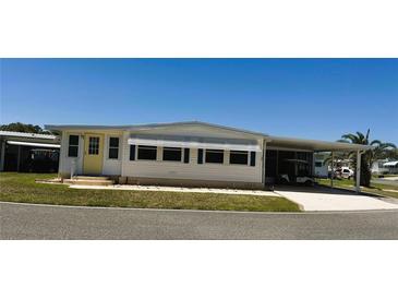 Charming single-story home with a covered carport and well-maintained landscaping at 129 Dogwood Trl, Leesburg, FL 34748