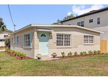 Charming single-story home with a light blue front door and shutters, set against a well-maintained lawn at 1600 Hart Ln, Orlando, FL 32804