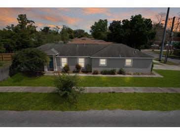 Charming single-story home with well-maintained lawn and neutral color palette at 1833 Courtland St, Orlando, FL 32804