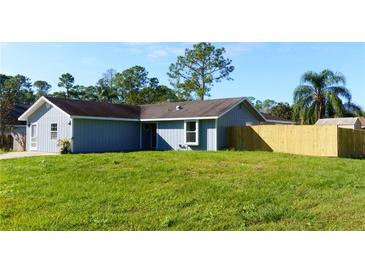 Charming single-story home featuring a spacious front yard with lush grass and a newly installed wooden fence at 3426 Somerset Ave, Deltona, FL 32738