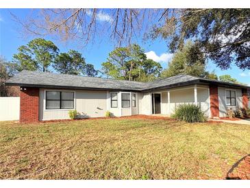 Charming single-story home with a well-maintained lawn and mature trees offering great curb appeal at 5704 Sw 108Th St, Ocala, FL 34476
