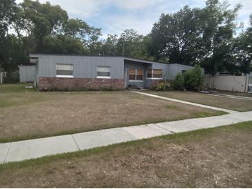 Charming single-story home with gray siding and a well-maintained front yard at 7406 Nolton Way, Orlando, FL 32822