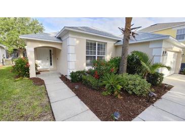 Charming single-story home featuring a manicured lawn and a welcoming front entrance at 8457 Secret Key Cove, Kissimmee, FL 34747