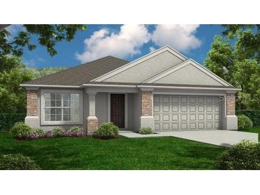 Charming single-story home with stone accents and a well-manicured lawn at 989 Lunar Ln, Winter Haven, FL 33884