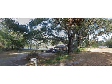 Single story home on a large lot with mature trees and a lake view at 5845 Corbett Ave, Mulberry, FL 33860