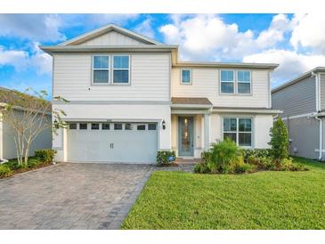 Charming two-story home with a well-manicured lawn and a two car garage at 6066 Arbor Watch Loop, Orlando, FL 32829