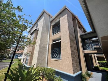 Exterior of a two-story condo with blue railings on the balconies and well-maintained landscaping at 7320 Westpointe Blvd # 531, Orlando, FL 32835