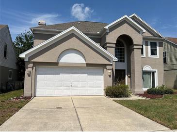 Charming two-story stucco home with a two-car garage and well-maintained landscaping at 904 W Charing Cross Cir, Lake Mary, FL 32746
