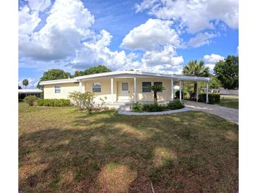 Charming single-story home with a covered carport and well-maintained lawn, perfect for relaxed living at 15 Ne 63Rd Ct, Ocala, FL 34470