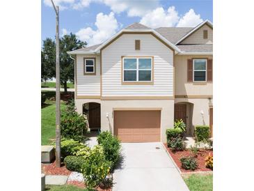 Charming two-story townhome featuring a well-maintained lawn and attached one car garage at 3850 Hampstead Ln, Lakeland, FL 33810