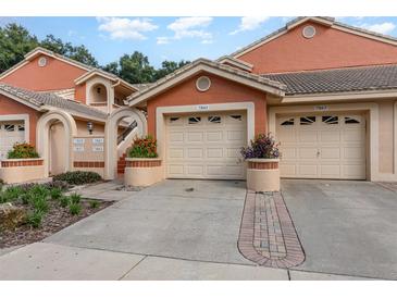 Charming townhome featuring attached garages, vibrant landscaping, and a well-maintained exterior at 7863 Sugar Bend Dr # 7863, Orlando, FL 32819