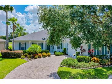 Single-story home with landscaped yard and paver driveway at 235 Anastasia Dr, Poinciana, FL 34759