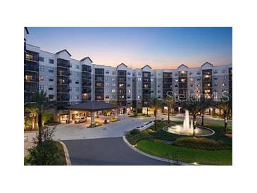 Beautiful exterior view of the property featuring a grand entrance, fountain, and lush landscaping at 14501 Grove Resort Ave # 1637, Winter Garden, FL 34787