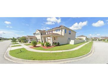 A charming two-story home with lush landscaping in a suburban neighborhood at 2585 Needlepoint St, Kissimmee, FL 34741