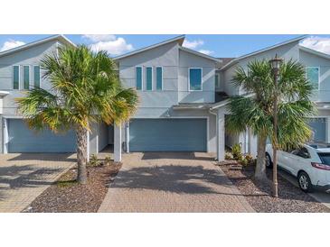 Charming two-story townhome features an attached garage, modern architecture, and well-maintained landscaping at 3359 Bellezza Ct, Kissimmee, FL 34746