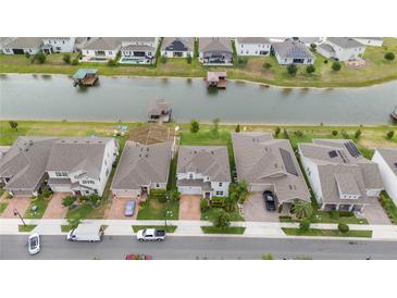 Aerial view of houses and a canal in a residential neighborhood at 3241 Wauseon Dr, Saint Cloud, FL 34772