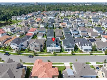 An aerial view shows a residential neighborhood with well-maintained homes, streets, and landscaping at 1862 Beach Ridge Rd, Celebration, FL 34747