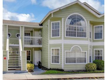 Charming two-story condo featuring multiple windows and well-maintained landscaping at 3145 Britannia Blvd # D, Kissimmee, FL 34747