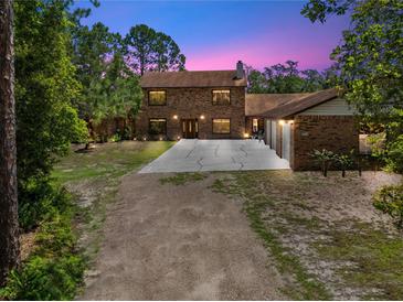 Beautiful two-story brick home with well-maintained landscaping and a long driveway at 1775 Sundance Dr, St Cloud, FL 34771