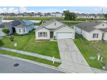 One-story house with a garage and solar panels, well-maintained lawn at 816 William Way, Haines City, FL 33844