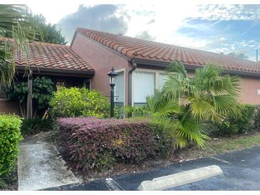 Charming home featuring a red tile roof and nicely landscaped front yard at 618 Saint Johns Ct, Winter Park, FL 32792