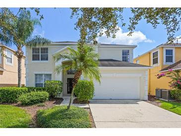 Charming two-story home with a well-maintained lawn, beautiful landscaping and two car garage at 121 Madiera Beach Blvd, Kissimmee, FL 34746