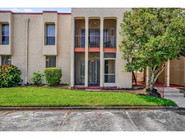 Charming condo featuring three archways and lush green lawn for a inviting curb appeal at 544 Orange Dr # 10, Altamonte Springs, FL 32701