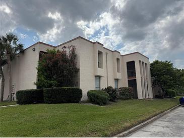 Exterior view of updated condominium building showcasing neutral color palette and well-kept lawn at 544 Orange Dr # 10, Altamonte Springs, FL 32701