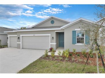 Beautiful single Gathering home with a two-car garage, fresh landscaping, and grey exterior paint at 2107 Riley Ave, Eagle Lake, FL 33839