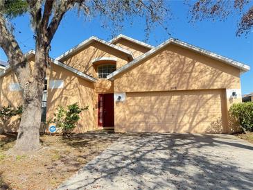 Charming single Gathering home with a well-manicured lawn and a two-car garage at 2109 Woodsedge Dr, Kissimmee, FL 34746