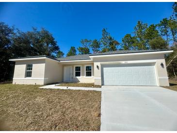 New construction home with attached garage and driveway at 6809 149Th Lane Rd, Ocala, FL 34473